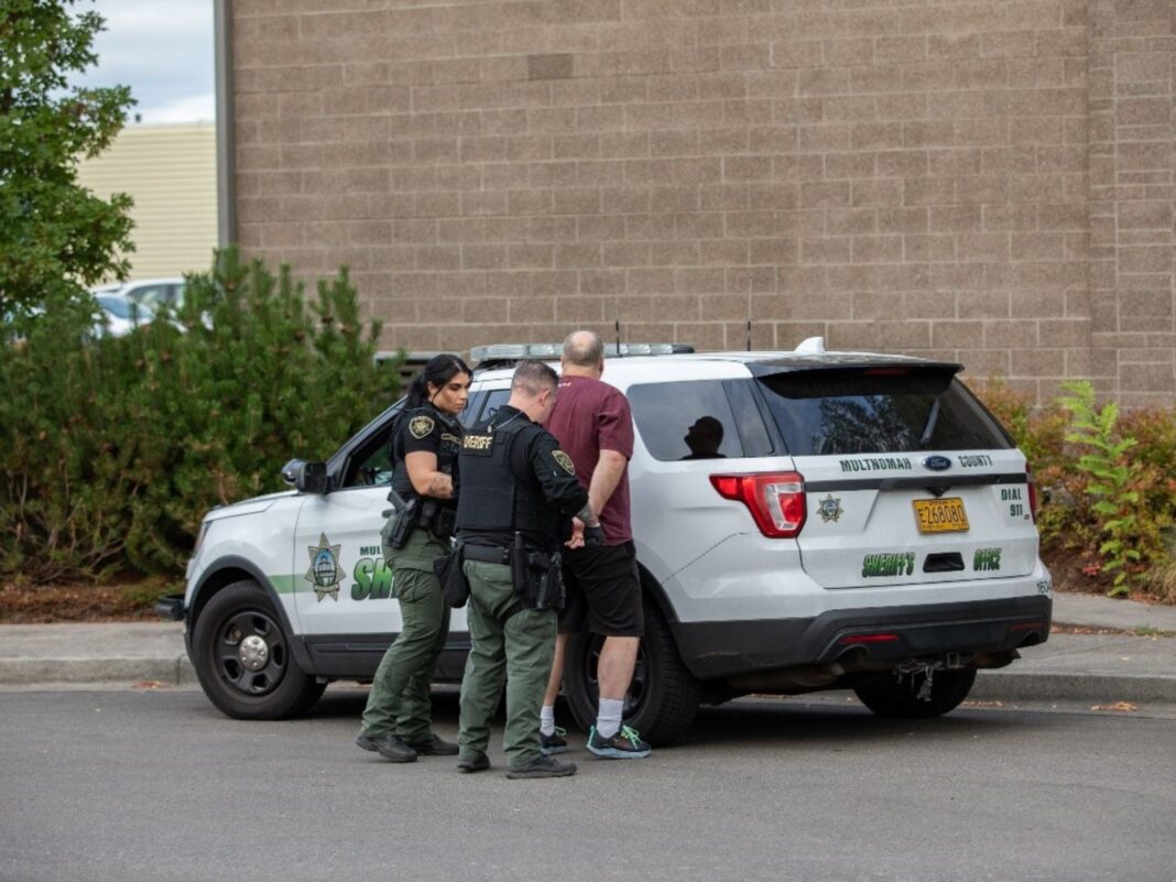 man being arrested by Multnomah County Sheriff's Office during mission